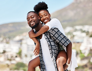 Image showing Portrait, black couple and back ride with a smile in nature outdoors on a date, trip or vacation. Love, romance and happy man and woman together with male carrying female on his shoulders outside.