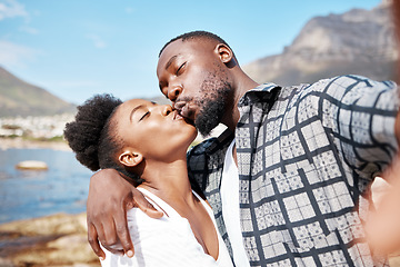 Image showing Couple kiss in a selfie at the beach in summer to post it on social media on a sunny day in nature together. Travel, love and black woman kissing her African boyfriend in an ocean portrait on holiday