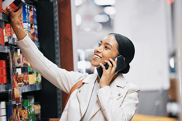 Image showing Happy supermarket, grocery shopping and customer with 5g phone, smile and in retail store for food, groceries or product from shelf. Woman with smartphone, communication of sale and on call in shop