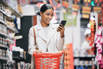 Image showing Phone, 5g internet and grocery shopping Indian woman reading a funny text or social media content. Comic web, mobile and online scroll at a retail food store with a happy customer smile from India