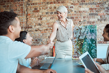 Image showing Handshake, deal and business woman in art gallery coaching or planning museum exhibition. Business meeting, team and welcome with manager shaking hands with employee in collaboration workshop