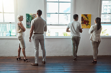 Image showing Art, painting and men and women at a gallery exhibition with paintings. Culture, creativity and sales, museum visitors standing at a canvas. Beauty, presentation and discussion on creative artwork.