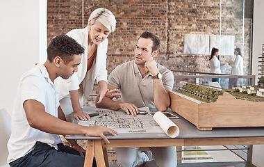 Image showing Architect, builder and engineer meeting and working as a team in an office with a blueprint and planning in the construction industry. Teamwork and collaboration on a building design or project