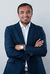 Image showing Young beautiful focused european businessman. Front view of man with dark hair clothing casual business formal jacket Isolated on gray background