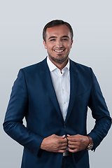 Image showing Young beautiful focused european businessman. Front view of man with dark hair clothing casual business formal jacket Isolated on gray background