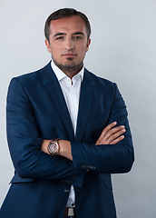 Image showing Young beautiful focused european businessman. Front view of man with dark hair clothing casual business formal jacket Isolated on gray background