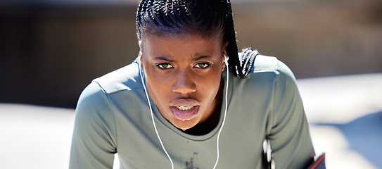 Image showing Runner, workout and exercise athlete tired after running or training for a marathon with earphone. Health, wellness and motivation or healthy and strong fitness black woman relax after sports cardio