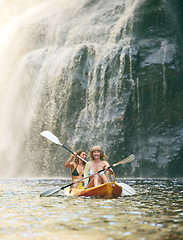 Image showing Kayak, summer and friends on river, nature and vacation adventure together in bikini swimsuit. Holiday, waterfall and freedom with young happy women rowing in a canoeing boat travel activity