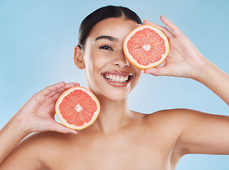 Image showing Beauty, health and woman with clear skin and a grapefruit with nutrition and vitamins in a studio. Girl with a healthy, wellness and fresh skincare and selfcare routine with organic citrus fruit.