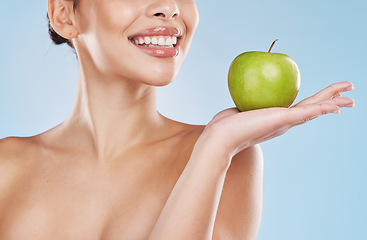 Image showing Health, beauty and woman with an apple and a wellness, healthy and organic lifestyle in studio. Girl with clear skin and fresh skincare routine holding a fruit with vitamins and nutrition for a diet.