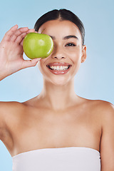 Image showing Portrait, health and beauty with woman with an apple for vitamins, minerals or nutrients. Healthy diet, lifestyle and skincare nutrition of girl from Brazil with fruit on her eye and a smile.