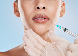 Image showing Plastic surgery, collagen and lip filler for facial beauty aesthetic and medical cosmetic surgery. Hands of face augmentation surgeon or doctor working on patient or client lips with injection needle