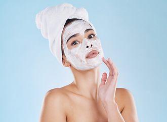 Image showing Skin care, face wash and mask on woman in studio with blue background and mockup. Young model in bathroom towel in a self care, beauty or cosmetic portrait for skin health and wellness with mock up