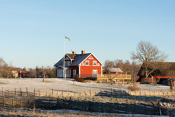 Image showing Typical red wooden house in winter