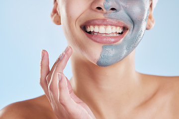 Image showing Skincare, beauty and face mask with a beautiful woman taking care of her clean, healthy and glowing skin. Closeup smile, wellness and charcoal or clay exfoliate product during routine treatment