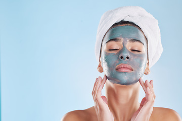 Image showing Facial, skincare and woman with face mask cream for beauty, health and wellness in studio with blue background. Cosmetics, product and young girl at luxury spa for acne treatment in a model portrait