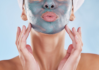 Image showing Skincare wellness, charcoal face mask and beauty product for healthy skin against blue mockup studio background. Model pouting mouth, care for body and natural cosmetic treatment for wellbeing
