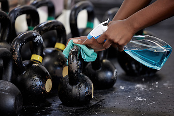 Image showing Gym cleaning hand spray bottle to sanitize dumbbell weights in gym. Woman cleaning equipment in hygiene routine to protect and prevent covid or corona through exercise with chemical liquid detergent