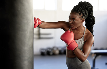 Image showing Boxer, workout and training girl with punching bag working on sports fitness, exercise and strength. Athlete, fighter or black woman in a boxing, health and wellness gym or martial arts fight club