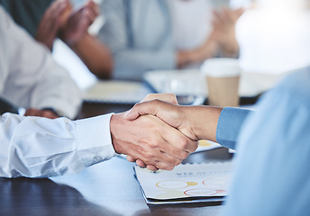 Image showing Businessman shaking hands with his partner to make a corporate deal at meeting in the office. Closeup of professional employees greeting with handshake at company conference, tradeshow or convention.