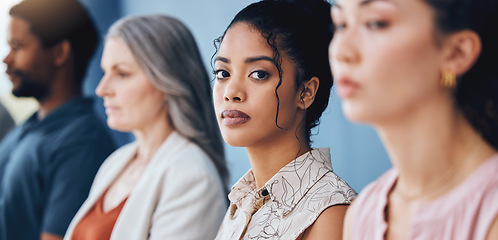 Image showing Training, learning and education with a business woman looking serious and sitting in a conference or workshop for coaching. Portrait of a female employee in an audience for a development seminar