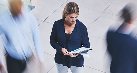 Image showing Business employee reading paperwork, crowd of people walking fast and serious corporate white woman stopping in lobby hall. Busy office building, hold company documents and people traffic blur motion