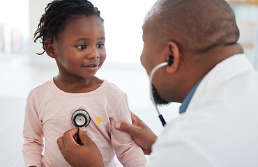 Image showing Healthcare, pediatrician and child heart doctor with a patient at hospital, exam on chest with a stethoscope. Black girl smile at pediatric surgeon, talking to a friendly, caring physician she trust