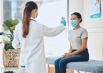 Image showing Healthcare, compliance and covid scan by doctor and patient with digital thermometer in a consultation room. Healthcare worker checking for fever and corona symptoms, practice safety during pandemic