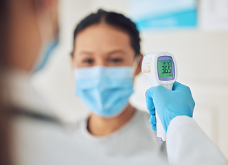 Image showing Covid doctor thermometer, patient safety check and corona virus risk in hospital, clinic and medical surgery. Hands of healthcare worker consulting wellness temperature, service test and fever laser