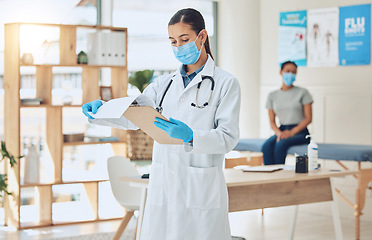 Image showing Doctor with mask and patient for medical test results documents at hospital in covid or corona global pandemic. Consulting healthcare woman worker with health insurance paperwork of sick girl