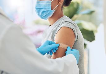 Image showing Covid vaccine with medical doctor or healthcare nurse hands with plaster on arm after medicine injection. Patient treatment or nursing for disease, sickness or flu at work in hospital or clinic.