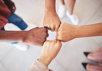 Image showing Hands, teamwork and collaboration with a team of business people joining their fists in a circle in solidarity, unity and support from above. Motivation, goal and a mission or vision for success