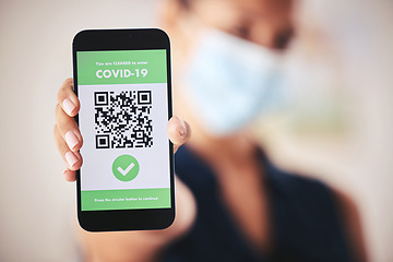 Image showing Covid passport, QR code and phone in the hand of a woman refugee or passenger ready for immigration and travel. Closeup of 5g mobile technology for safety during the global corona virus epidemic