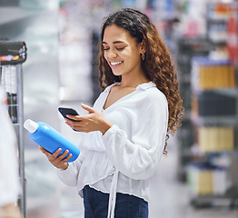 Image showing Woman shopping, phone and price check for inflation increase or discount coupon code. Young girl consumer calculating grocery tax of supermarket budget toiletries options on the shelf.