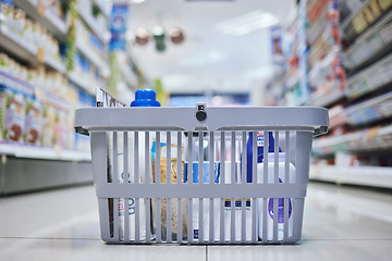 Image showing Supermarket, grocery and store basket on floor with food product, healthcare goods and grooming wellness shopping. Zoom on retail sales groceries in inflation economy after commerce financial budget