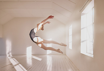 Image showing Woman ballet dancer dancing in a dance studio mockup white walls and sunlight. Young professional girl, art or sports student jumping mid air technique in a creative ballerina class