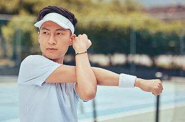 Image showing Tennis player stretching before game on court, training for professional sports competition and motivation for fitness sport performance during workout. Asian athlete at start of match in stadium