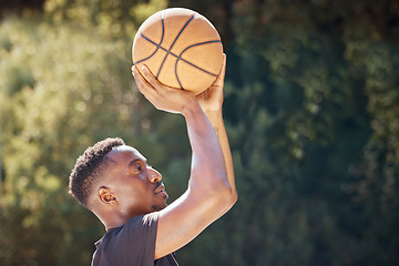 Image showing Basketball, sports and exercise workout of a man doing fitness, health and cardio training. Focus mindset of athlete shooting a ball to practice his aim for a sport game or match on a outdoors court