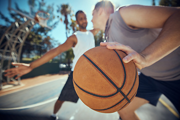 Image showing Basketball, competitive sports and practice match with men, players or friends playing a game at an outdoor court. Athletes staying fit and enjoying leisure activity with a ball while trying to score