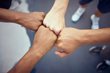 Image showing Teamwork, hands and collaboration with people standing in a circle or huddle in support, unity or solidarity. Team, group of community with fists joined in union together from above and closeup