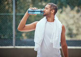 Image showing Sports, fitness and man on break drinking water after a workout, training session or exercise. Health, athlete and male trainer resting with refreshing liquid after playing a sport, running or cardio