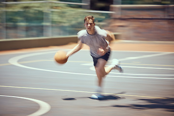 Image showing Basketball player, sports and training with a active, fit and fast man playing a game at an outdoor court. Professional athlete doing exercise for health and wellness during practice for a match