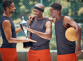 Image showing Award, success and basketball athletes with a trophy as a reward or prize after winning a competitive sports game. Challenge, fitness and happy African winners in celebration after mens championship