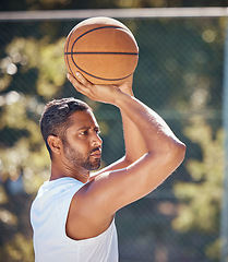 Image showing Basketball player, sports and training with fitness man with ball ready to shoot or throw while playing at an outdoor court. Serious athlete doing exercise or active game for health and wellness