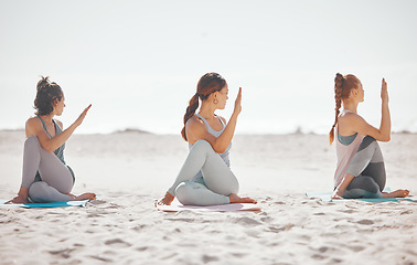 Image showing Zen, heath and yoga group meditation on a beach with women training and meditating together. Athletic friends exercise, practice posture and balance yoga pose with zen, peaceful energy in nature