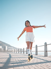 Image showing Summer, beach and roller skate woman with happy, relax and calm smile feeling free at the sea. Happiness of a female skater with freedom, movement and fun exercise in the sun in nature by a beach