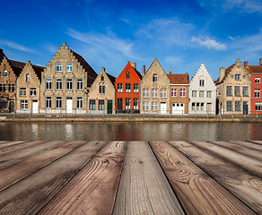 Image showing Wooden planks table with European town in background