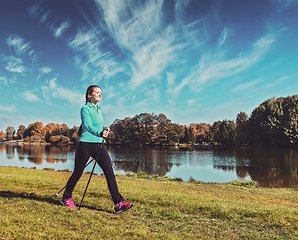 Image showing Young woman nordic walking