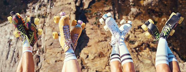 Image showing Roller skates, fun and adventure travel with friends group lifting legs and showing off retro skating footwear while outside. Group of women enjoying hobby, freedom and activity on holiday together