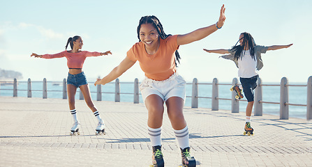 Image showing Friends, fitness and roller skating at the beach in summer as a group of young gen z girls and boy skate in freedom. Smile, happy and active people riding blades on the promenade on holiday vacation